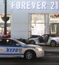 Police stand guard at the scene of a vehicular accident on 34th Street, Thursday, Dec. 11, 2014, in New York. Six people were hurt when the car jumped a curb in midtown Manhattan and struck a group of people around 10 p.m. A fire department spokesman says the injured were taken to Bellevue hospital with serious but non-life threatening injuries. (AP Photo/John Minchillo)