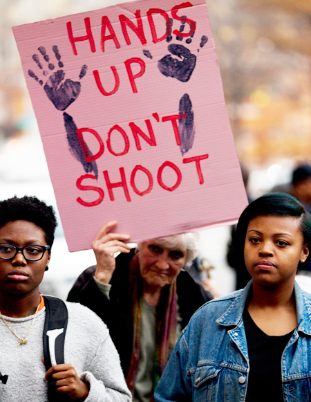 Demonstrators protest against the shooting death of unarmed 18-year-old Michael Brown, during a rally at the Department of Justice in Washington, Monday. (AP)