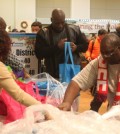 Local residents receive food baskets at the 5th Sharing the Holiday Spirit Food Drive by Chade Foundation and Bees Sales Company Saturday.