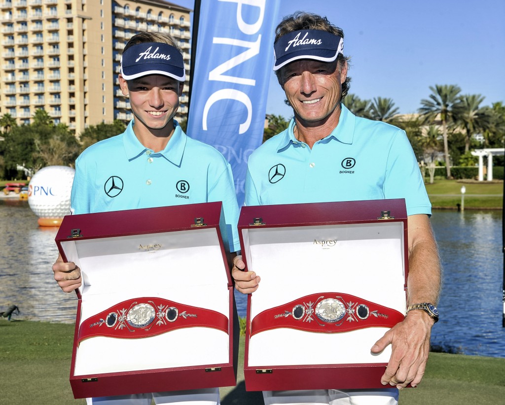 In this photo released by the PNC Father/Son Challenge, the Father/Son Challenge Golf winners Bernhard Langer, right, and son Jason, 14, pose with their first-place trophies in Orlando, Fla., Sunday, Dec. 14, 2014. (AP Photo/ PNC Father/Son Challenge, Geoff Bolte)