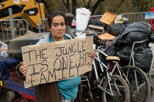 Yolanda Gutierrez, a 2-year resident of a homeless encampment known as The Jungle, holds a sign in protest Thursday, Dec. 4, 2014, in San Jose, Calif. (Marcio Jose Sanchez/AP)