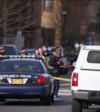 The scene in North Portland where a shooting occurred near Rosemary Anderson High School on Dec. 12, 2014. A shooter wounded two boys and a girl outside the high school Friday in what may be a gang-related attack, police said. (AP Photo/The Register-Guard, Bruce Ely)