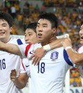 Ki Sung-yeung (from left) and Lee Keun-ho celebrate after Lee Jeong-hyeop (18) scored what turned out to be the game-winning goal. (Yonhap)
