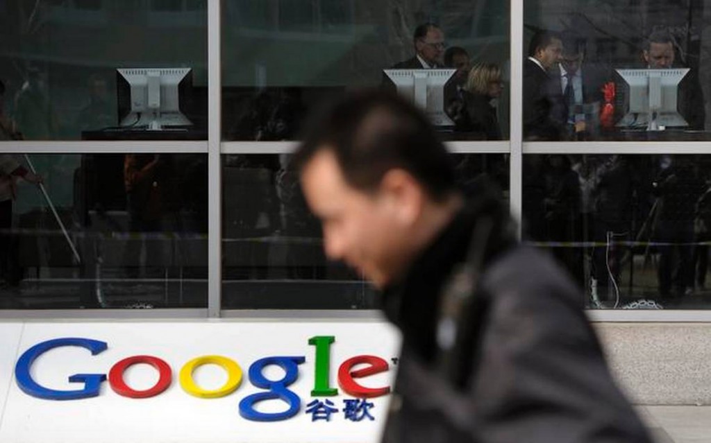 A security guard walks past a Google building. (AP Photo/Andy Wong)