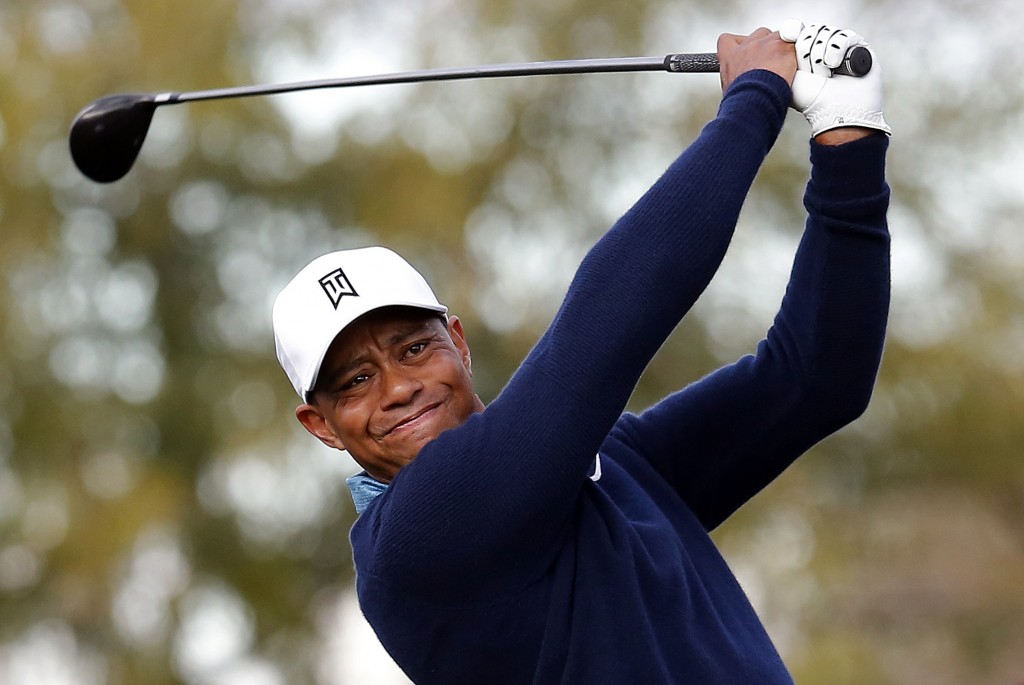 Tiger Woods hits a tee shot on the ninth hole during a practice round for to the Phoenix Open golf tournament on Tuesday, Jan. 27, 2015, in Scottsdale, Ariz. (AP Photo/Rick Scuteri)
