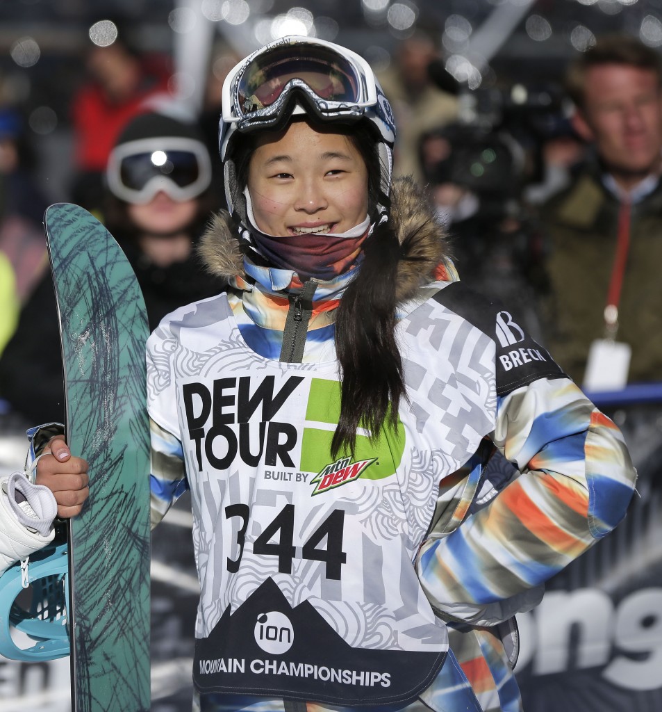 In this Dec. 14, 2013, file photo, Chloe Kim watches the replay of her second run during the snowboarding superpipe final at the Dew Tour iON Mountain Championships in Breckenridge, Colo. Kim took third place in the event. One of the best snowboarders in the world was too young to go to the Sochi Olympics a year ago. So teenager Chloe Kim watched the halfpipe competition from the comfort of her living room while eating popcorn with her family. (AP Photo/Julie Jacobson, File)