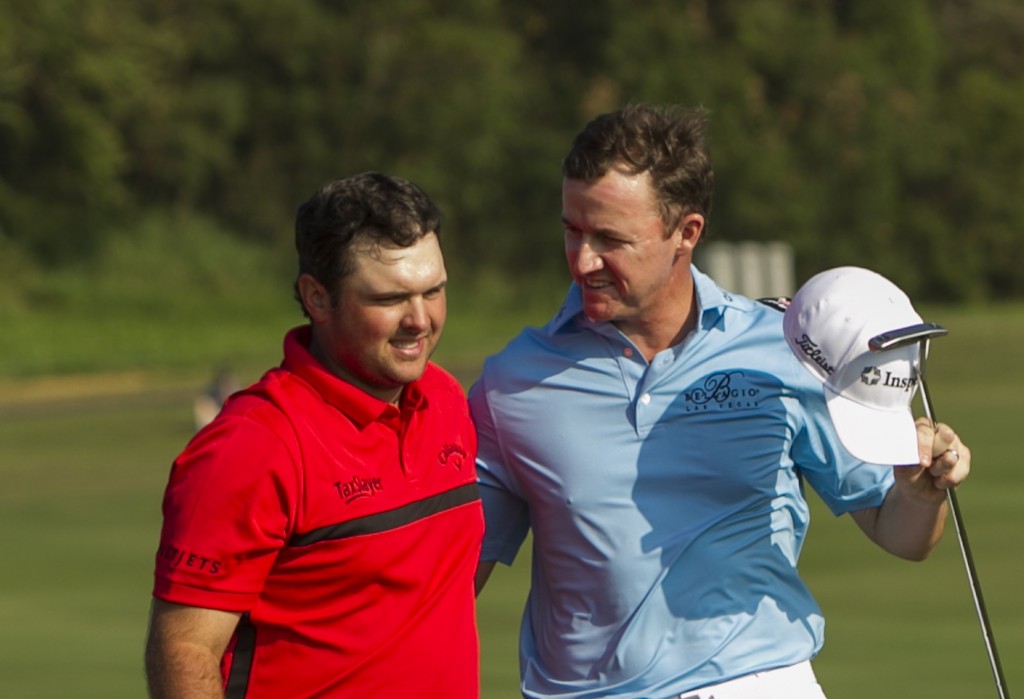 Patrick Reed, left, is congratulated by Jimmy Walker after Reed won a playoff hole to win the Tournament of Champions golf tournament, Monday, Jan. 12, 2015, in Kapalua, Hawaii.  (AP Photo/Marco Garcia)