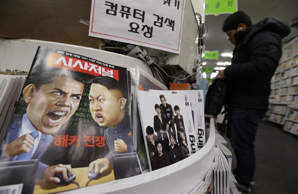 In this Saturday, Jan. 3, 2015 photo, a magazine with caricatures of U.S. President Barack Obama, left, and North Korean leader Kim Jong Un is displayed at a book store in Seoul, South Korea. The United States imposed new sanctions Friday on North Korean government officials and the country's defense industry for a cyberattack against Sony, insisting that Pyongyang was to blame despite lingering doubts by the cyber community. The red letters on the magazine read " Hacker War." (AP Photo/Ahn Young-joon)