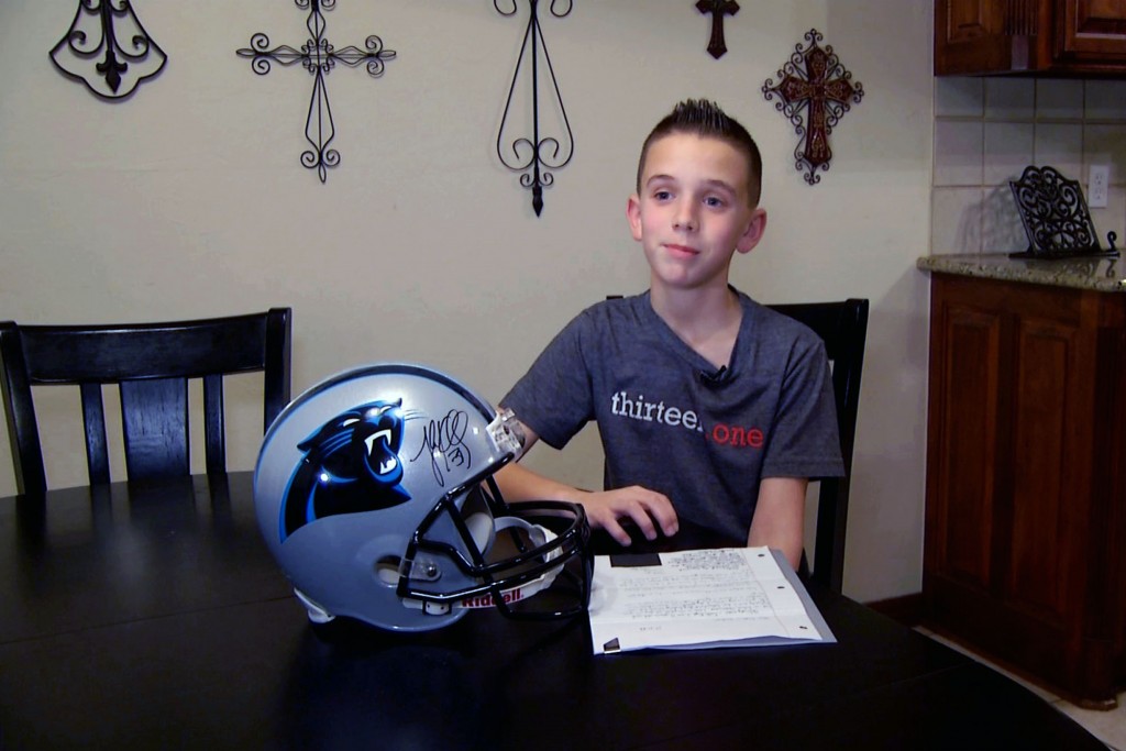 In this image from video, Cade Pope reads out aloud, a letter he wrote to the Carolina Panthers asking the NFL franchise why he should support them in Yukon, Okla. on Thursday, Jan. 15, 2015. Pope, 12, wrote all 32 teams asking the same question. (AP Photo/John L. Mone)