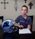 In this image from video, Cade Pope reads out aloud, a letter he wrote to the Carolina Panthers asking the NFL franchise why he should support them in Yukon, Okla. on Thursday, Jan. 15, 2015. Pope, 12, wrote all 32 teams asking the same question. (AP Photo/John L. Mone)