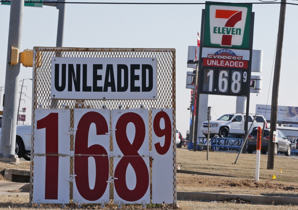 Signs at two gas stations advertise unleaded gasoline for $1.68, in Oklahoma City, Friday, Jan. 23, 2015. For the first time since 2009, most Americans are paying less than $2 a gallon. (AP Photo/Sue Ogrocki)