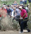 Tiger Woods hits out of the rough on the 11th hole in Scottsdale, Ariz. (AP Photo/Rick Scuteri)