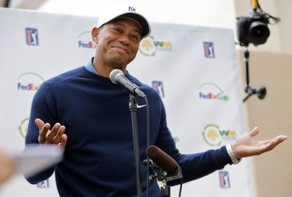 Tiger Woods gestures as he talks to the media after playing a practice round at the Phoenix Open golf tournament, Tuesday, Jan. 27, 2015, in Scottsdale, Ariz. (AP Photo/Rick Scuteri)