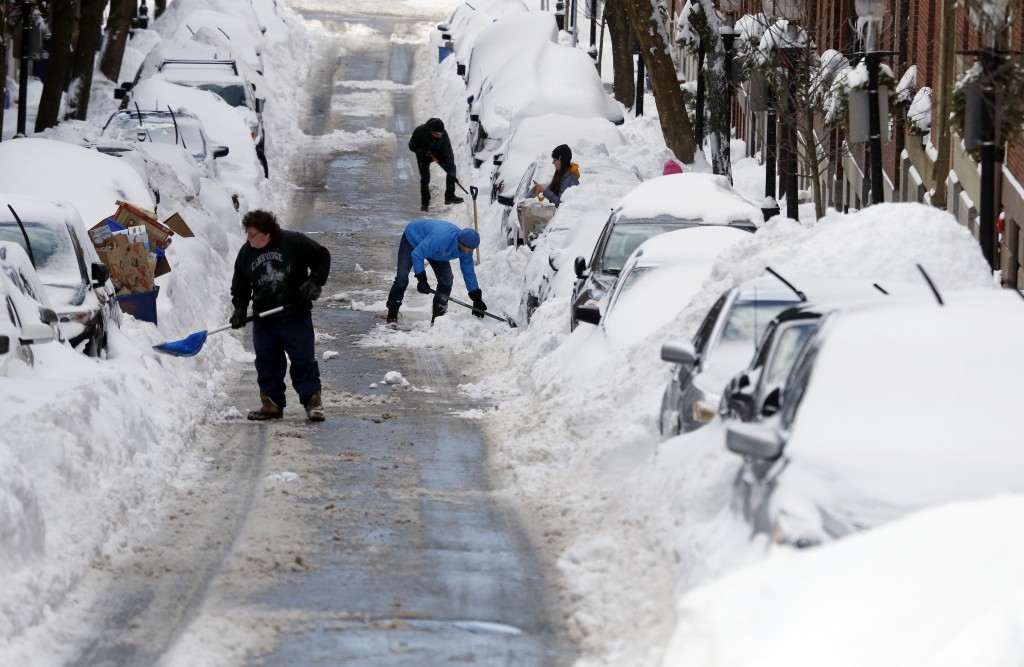 People work to shovel snow-covered cars out in Boston's Charlestown section, Wednesday, Jan. 28, 2015, one day after a blizzard dumped about two feet of snow in the city. (AP Photo/Elise Amendola)