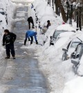 People work to shovel snow-covered cars out in Boston's Charlestown section, Wednesday, Jan. 28, 2015, one day after a blizzard dumped about two feet of snow in the city. (AP Photo/Elise Amendola)
