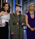 In this image released by NBC, Tiny Fey, from left, Margaret Cho and Amy Poehler speak at the 72nd Annual Golden Globe Awards on Sunday, Jan. 11, 2015, at the Beverly Hilton Hotel in Beverly Hills, Calif. (AP Photo/NBC, Paul Drinkwater)