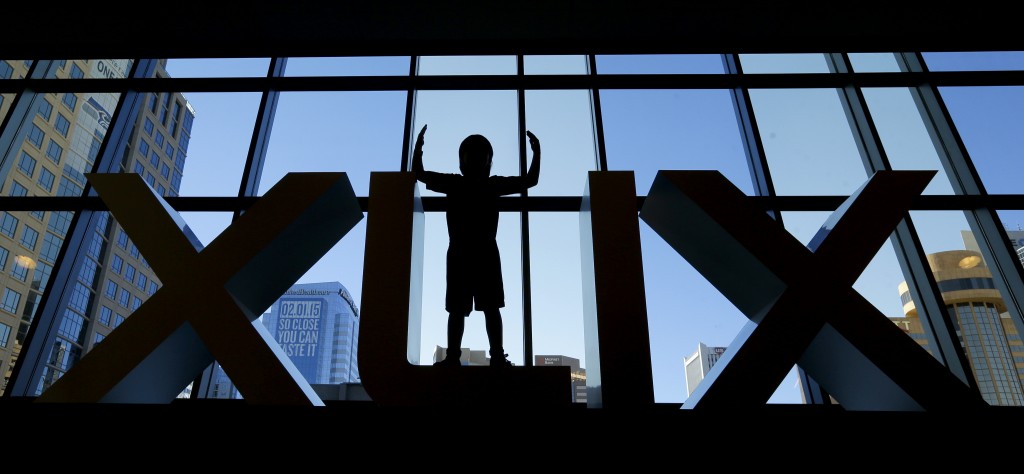 Diego Santa Cruz, 8, from Phoenix, poses for a photo in a set of Roman numerals at the Super Bowl XLIX NFL Experience Saturday, Jan. 24, 2015, in Phoenix. (AP Photo/Charlie Riedel)