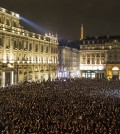 Thousands of people gather for a moment of silence to pay their respects to the victims of the deadly attack at the Paris offices of French satirical newspaper Charlie Hebdo, in Lyon, central France, Wednesday, Jan. 7, 2015. Masked gunmen stormed the Paris offices of a weekly newspaper that caricatured the Prophet Muhammad, killing at least 12 people, including the editor, before escaping in a car. It was France's deadliest postwar terrorist attack. (AP Photo/Laurent Cipriani)
