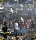 Rescue workers comb through the rubble of a children's hospital after a gas truck exploded, in Cuajimalpa on the outskirts of Mexico City, Thursday, Jan. 29, 2015. The powerful explosion shattered the hospital on the western edge of Mexico's capital, killing at least three adults and one baby and injuring dozens. (AP Photo)