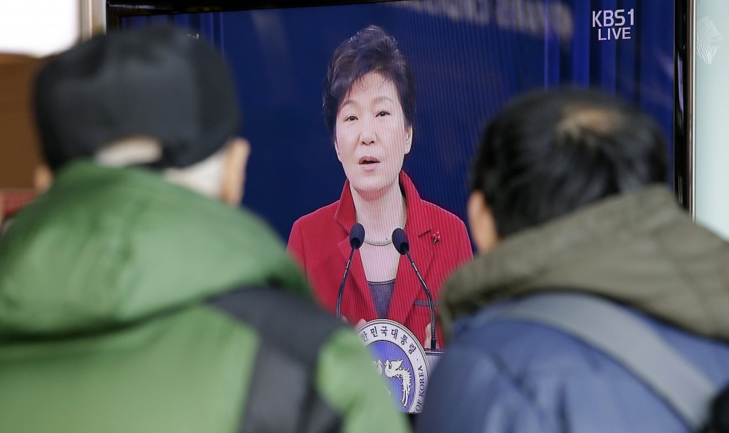 People watch a live television program airing South Korean President Park Geun-hye's New Year's press conference at the Seoul Railway Station in Seoul, Monday, an. 12, 2015. (AP Photo/Lee Jin-man)