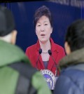 People watch a live television program airing South Korean President Park Geun-hye's New Year's press conference at the Seoul Railway Station in Seoul, Monday, an. 12, 2015. (AP Photo/Lee Jin-man)