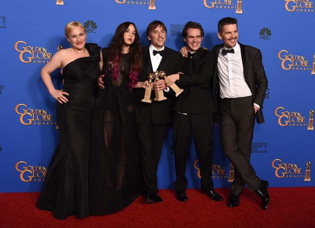 Patricia Arquette, from left, Lorelei Linklater, Richard Linklater, Ellar Coltrane and Ethan Hawke pose in the press room with the award for best motion picture - drama for Boyhood at the 72nd annual Golden Globe Awards at the Beverly Hilton Hotel on Sunday, Jan. 11, 2015, in Beverly Hills, Calif. (Photo by Jordan Strauss/Invision/AP)