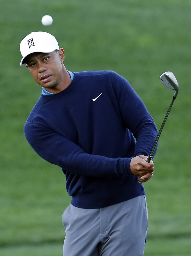 Tiger Woods hits out of the bunker on the ninth hole at the Phoenix Open. (AP Photo/Rick Scuteri)