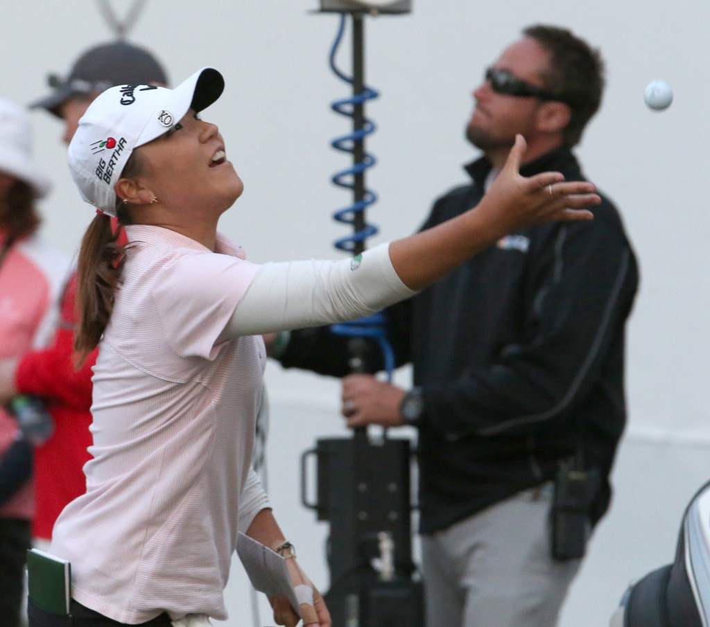 Lydia Ko, of New Zealand, tosses her ball to a fan after finishing the third round of the LPGA's Coates Golf Championship, Friday, Jan. 30, 2015, in Ocala, Fla. (AP Photo/The Star-Banner, Bruce Ackerman)