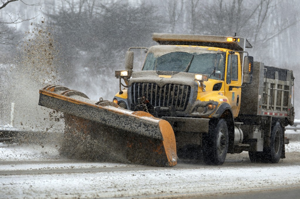 A Pennsylvania Department of Transportation truck plows snow from an overpass on Monday, Jan. 26, 2015, in Evans City, Pa. Over three inches of snow had already fallen and more is on the way as the storm moves across the northeast of the country. (AP Photo/Keith Srakocic)