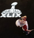 Two-year-old Kai Ezell-Tapia, from Phoenix, watches a video display at the Super Bowl XLIX NFL Experience Saturday, Jan. 24, 2015, in Phoenix. (AP Photo/Charlie Riedel)