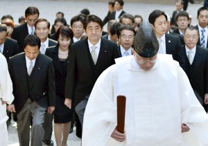 Japan's Prime Minister Shinzo Abe, center, and his cabinet ministers, escorted by a Shinto priest, arrive at the Grand Shrine of Ise, central Japan, for offering a new year's prayer Monday, Jan. 5, 2015.  Japanese Prime Minister Abe said Monday that his government would express remorse for World War II on the 70th anniversary of its end in August. (AP Photo/Kyodo News)