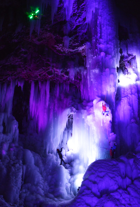 A climber ascends LED light-reflected ice cliff in Wonju, Gangwon Province, Tuesday, during a night ice climbing event held by Mammut Korea. (Korea Times photo by Yun Suh-young)