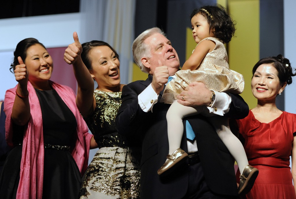 Maryland Gov. Larry Hogan, center, smiles with his daughter Jaymie Sterling, left, daughter Kim Velez, second from left, granddaughter Daniella Velez, 2, and wife Yumi, right, during his inaugural gala in Baltimore, Wednesday, Jan. 21, 2015. Hogan is the 62nd governor of Maryland. (AP Photo/Steve Ruark)