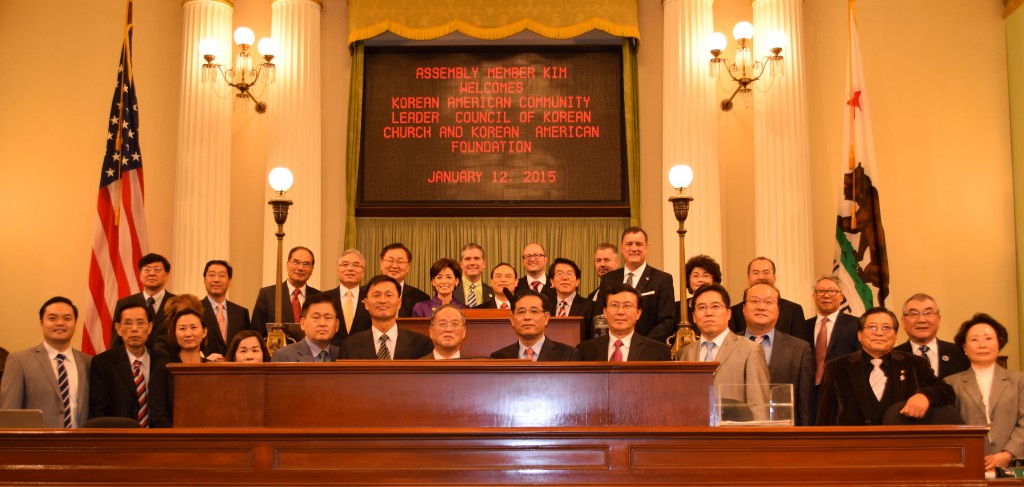 Assemblywoman Young Kim and Korean American organization members celebrate a unanimous committee vote for the Korean American Day bill Monday. 