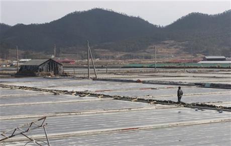 In this Feb. 19, 2014, a salt farm owner walks around his salt farm on Sinui Island, South Korea. Slavery thrives on this chain of rural islands off South Korea’s rugged southwest coast, nurtured by a long history of exploitation and the demands of trying to squeeze a living from the sea. Five times during the last decade, revelations of slavery involving the disabled have emerged, each time generating national shame and outrage.(AP Photo/Ahn Young-joon)