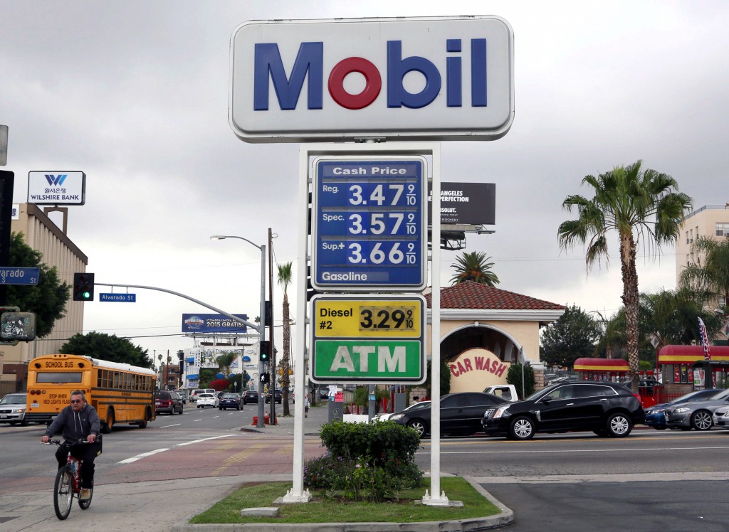 A cyclist rides by a sign at a gas station in Los Angeles posting the latest gas prices on Friday, Feb. 27, 2015. Gas prices in California soared overnight as a result of a combination of supply-and-demand factors worsened by the shutdown of two refineries that produce a combined 16 percent of the states gasoline. (AP Photo/Nick Ut)
