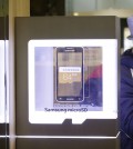 An advertisement of Samsung Electronics' micro SD cards is seen at a Samsung Electronics shop in Seoul, South Korea, Thursday, Jan. 29, 2015. Samsung Electronics Co. said lost the battle of the big phones last quarter as Apple's copycat large iPhone lured buyers in the crucial Chinese market. The South Korean company said Thursday its profit sank last quarter, with an improvement in its semiconductor business insufficient to mask its mobile problems. (AP Photo/Ahn Young-joon)