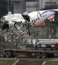 The main fuselage from TransAsia Airways Flight 235 is hoisted away in Taipei, Taiwan, Thursday, Feb. 5, 2015. The commercial plane crash with 58 people aboard clipped a bridge shortly after takeoff and crashed into a river in the island's capital of Taipei on Wednesday morning. (AP Photo/Wally Santana)