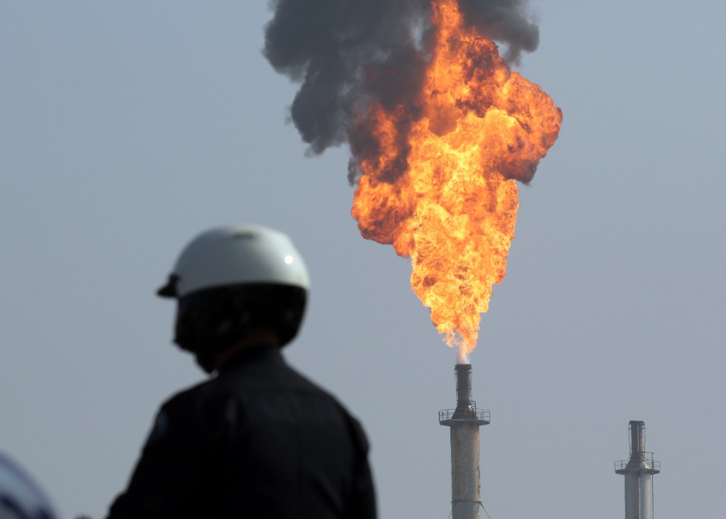 A very large smokestack flare burns off flammable product after an explosion in a processing facility at the ExxonMobil refinery in Torrance, Calif. on Wednesday, Feb. 18, 2015. A small ground fire was quickly extinguished and the facility's flare system was triggered for safety reasons. Two workers suffered minor injuries. (AP Photo/Daily Breeze, Chuck Bennett)