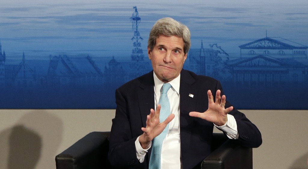 U.S. Secretary of State John Kerry gestures as he takes place on the podium during the 51. Security Conference in Munich, Germany, Sunday, Feb. 8, 2015.  (AP Photo/Matthias Schrader)