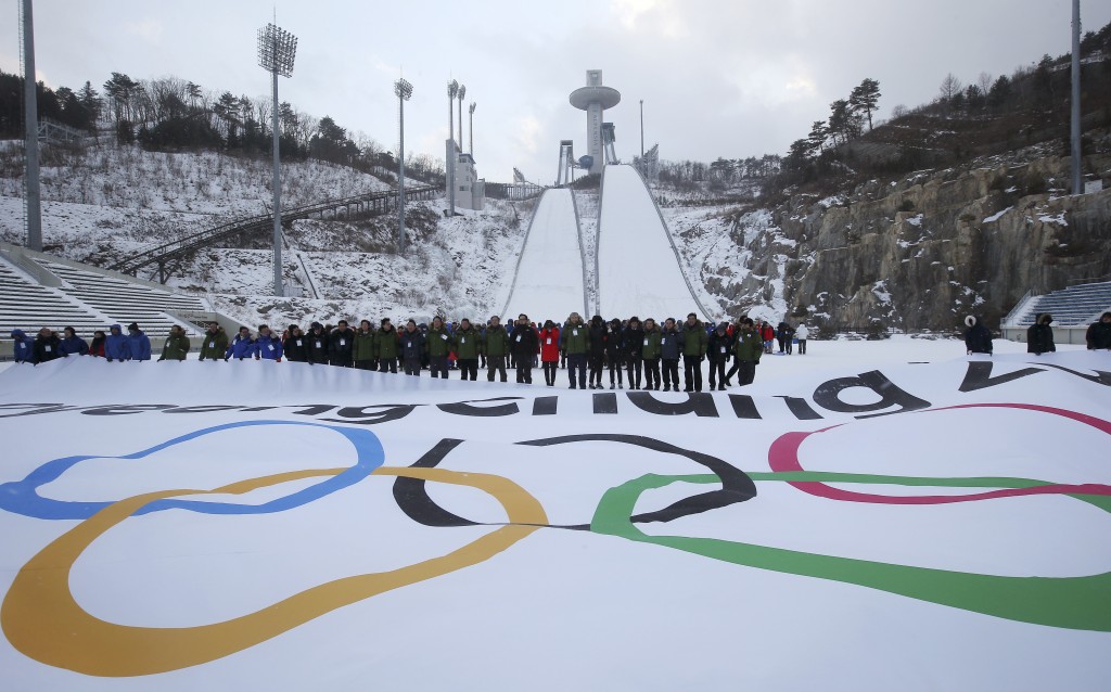 Participants attend an event marking the three-year countdown to the start of the 2018 Winter Olympics at Alpensia Ski Jumping Centre in Pyeongchang, South Korea, Monday, Feb. 9, 2015. The South Korean government recently rejected a proposal by the International Olympic Committee to halt construction on a new bobsled, luge and skeleton venue and relocate the events to an existing sliding center in another country. The IOC said the move would have saved $120 million in construction costs and $3.5 million in yearly maintenance fees.(AP Photo/Yonhap, Han Jong-chan)