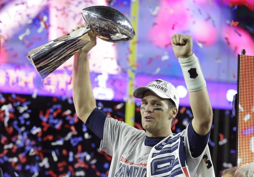 New England Patriots quarterback Tom Brady celebrates with the Vince Lombardi Trophy after the NFL Super Bowl XLIX football game against the Seattle Seahawks Sunday, Feb. 1, 2015, in Glendale, Ariz.  The Patriots won 28-24. (AP Photo/Michael Conroy)