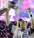 New England Patriots quarterback Tom Brady celebrates with the Vince Lombardi Trophy after the NFL Super Bowl XLIX football game against the Seattle Seahawks Sunday, Feb. 1, 2015, in Glendale, Ariz.  The Patriots won 28-24. (AP Photo/Michael Conroy)