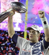 New England Patriots quarterback Tom Brady celebrates with the Vince Lombardi Trophy after the NFL Super Bowl XLIX football game against the Seattle Seahawks Sunday, Feb. 1, 2015, in Glendale, Ariz.  The Patriots won 28-24. (AP Photo/Michael Conroy)