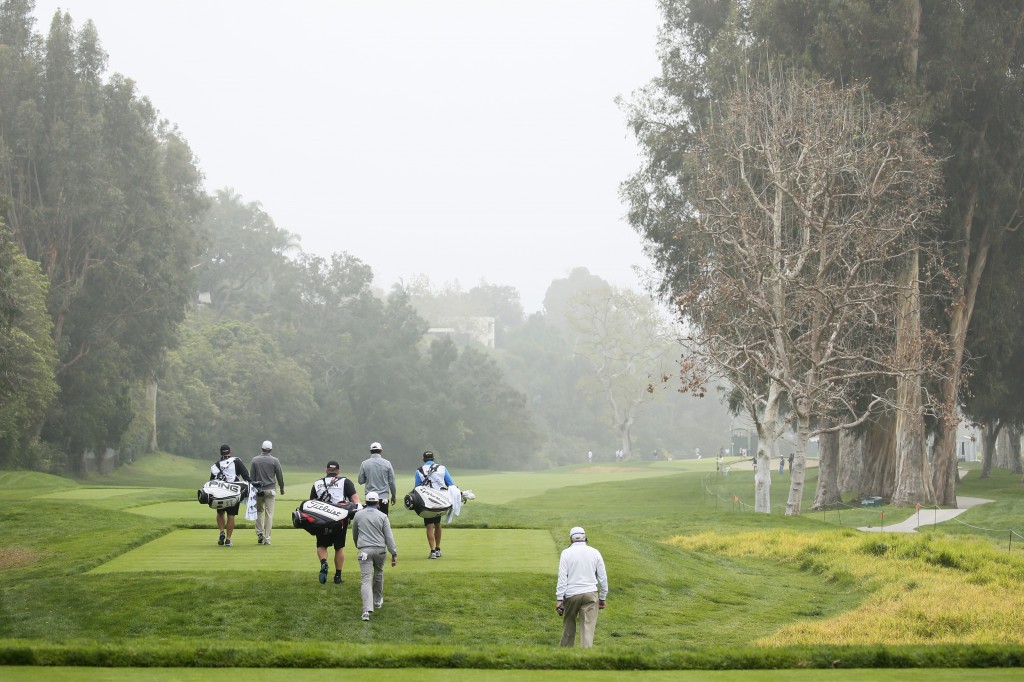 The grouping of Carlos Ortiz, left, and Erik Compton, center, and James Hahn, right, walk down the fairway after teeing off on the 12th hole during the first round of the Northern Trust Open golf tournament at Riviera Country Club in the Pacific Palisades area of Los Angeles on Thursday, Feb. 19, 2015. (AP Photo/Danny Moloshok)