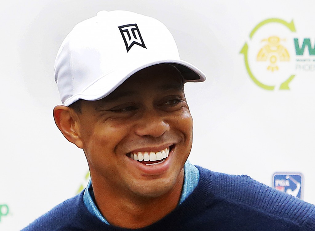 Tiger Woods talks to the media after playing a practice round at the Phoenix Open golf tournament on Tuesday, Jan. 27, 2015, in Scottsdale, Ariz. (AP Photo/Rick Scuteri)