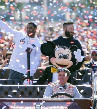 In this image provided by Disneyland, New England Patriots players Julian Edelman, right, and Malcolm Butler join Mickey Mouse as they celebrated their teams Super Bowl XLIX championship victory over the Seattle Seahawks at Disneyalnd park in Anaheim, Calif., on Monday, Feb. 2, 2015. (AP Photo/Disneyland, Paul Hiffmeyer)