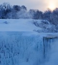 The sun rises over masses of ice formed around the Canadian 'Horseshoe' Falls in Niagara Falls, Ontario, Canada, Thursday, Feb. 19, 2015. (AP Photo/The Canadian Press,Aaron Lynett)