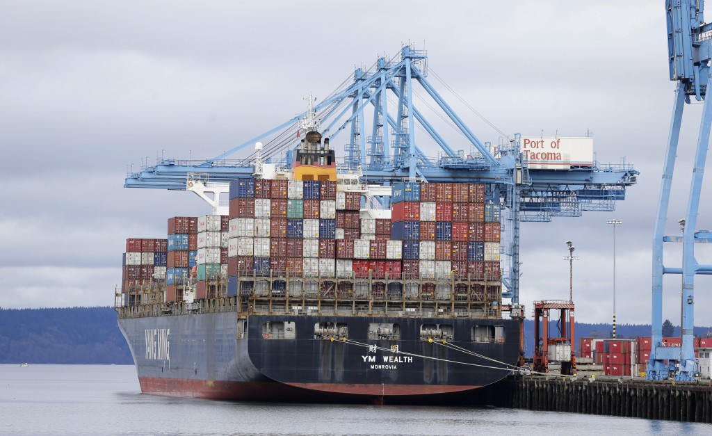 A cargo container ship operated by Yang Ming Marine Transport Corp. sits docked at the Port of Tacoma, Friday, Feb. 20, 2015, in Tacoma, Wash. With a Friday deadline looming, negotiators for the two sides in the contract dispute that has snarled international trade at U.S. West Coast seaports are laboring to reach a settlement as billions of dollars of cargo are sitting massive ocean-going ships anchored outside port facilities. (AP Photo/Ted S. Warren)