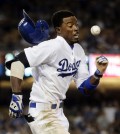 In this Sept. 22, 2014 file photo, Los Angeles Dodgers' Dee Gordon runs to first base with the throw during the 10th inning of a baseball game against the San Francisco Giants in Los Angeles. Gordon was out at first. The photo was part of a series of images by photographer Jae C. Hong which won the Thomas V. diLustro best portfolio award for 2014 given out by the Associated Press Sports Editors during their annual winter meeting in Orlando, Fla. (AP Photo/Jae C. Hong)